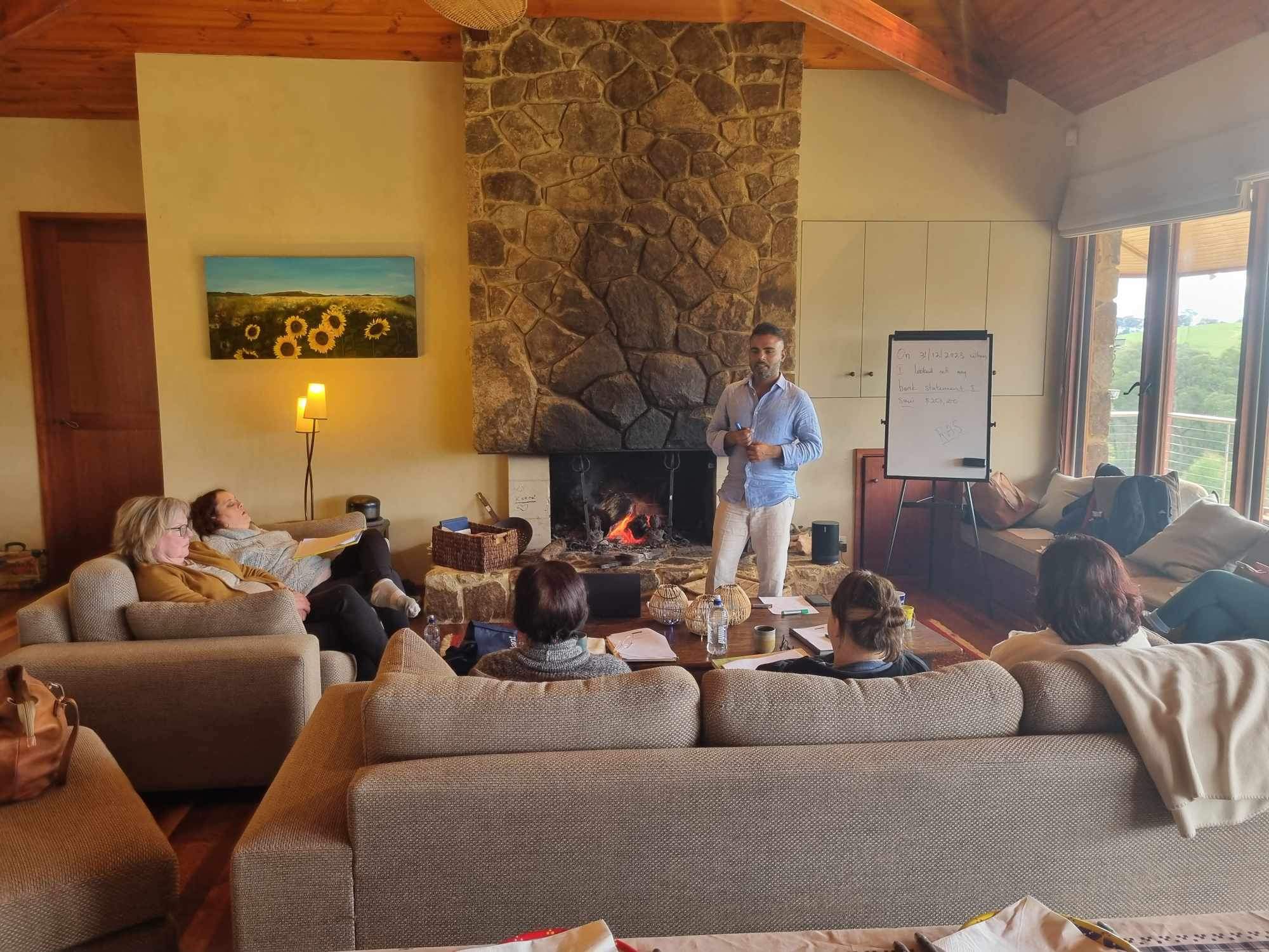 Haran facilitating an intimate fireside retreat session